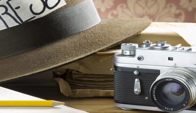 Pencil, camera and trilby with press card