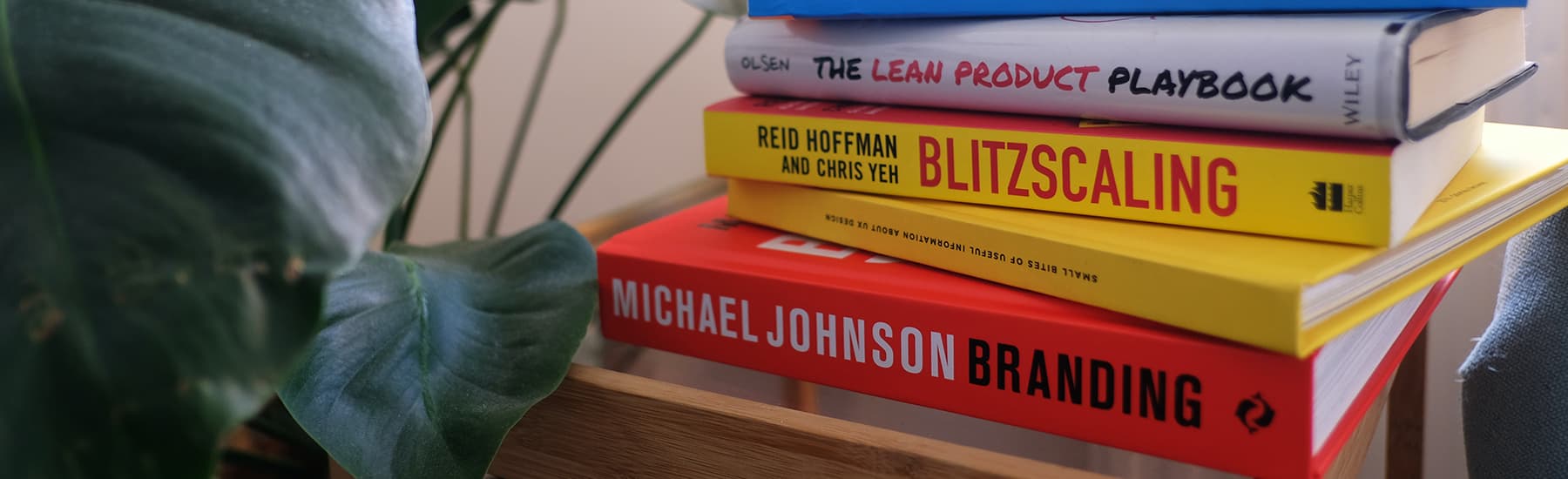 A pile of books about branding and brand repositioning on a table.